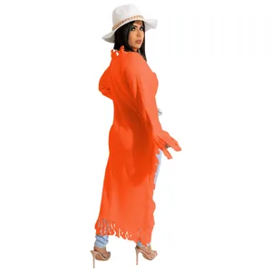 Back view of orange long knit sweater with fringe tassels and distressed collar