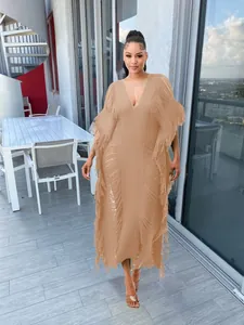 Detailed view of handmade knitted see-through long dress with elegant fringe accents.