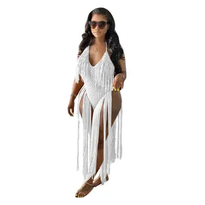 Detailed view of white hollow knit one-piece swimsuit featuring long dramatic tassels.