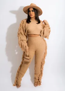 Full view of the two-piece knit set showing the textured fabric and fringe details.