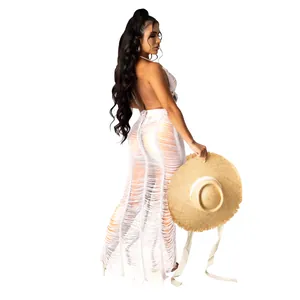 Sexy white hollow-out knitted beach maxi skirt with straw hat accessory detail.