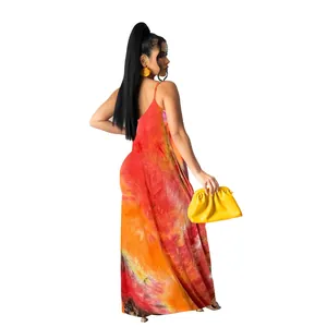 Back view of a model in a vibrant tie-dye maxi dress with yellow clutch bag