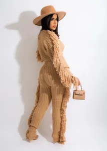 Full view of the beige knitted set with fringe details on sleeves and legs.