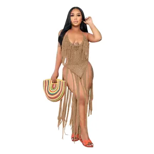 Front view of a model wearing a tan crochet bodysuit featuring dramatic long fringe tassels