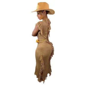 Back view of a sleeveless brown knit dress featuring fringe tassel details and a matching hat