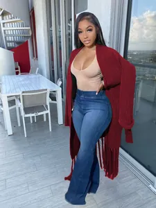 Elegant full-length view of a burgundy long-line knit cardigan featuring fringe detailing