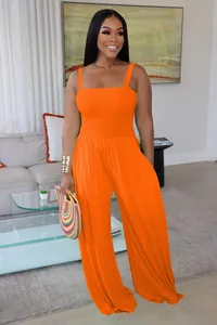 Detailed view of the vibrant orange smocked bodice on a casual wide-leg jumpsuit