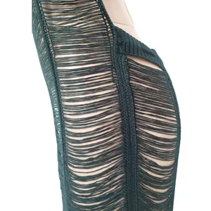 Detail view of a sexy dark green knitted beach maxi dress with hollow-out fringe design