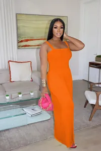 Elegant orange sleeveless wide-leg jumpsuit for women in a casual living room setting
