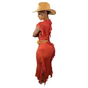 Side view detail of a burnt orange knitted sleeveless dress with stylish fringe accents