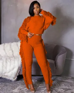 Detailed view of women's orange knitted two-piece set with fringe tassel sleeves and pants