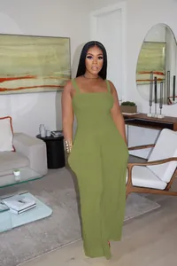 Close-up detail of the olive green smocked square-neck wide-leg jumpsuit on model