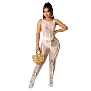 Full body view of a white knit shredded texture jumpsuit for sexy beach outings