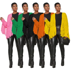 Selection of colorful boho knit cardigans featuring long fringe details and open front.