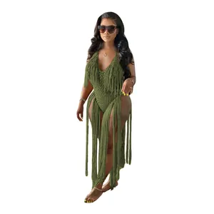 Full view of the green crochet one-piece swimsuit with long fringe details on a model