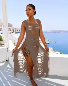 Detailansicht braunes Häkel-Strandkleid mit künstlerischen Cut-Outs und Fransen-Quasten