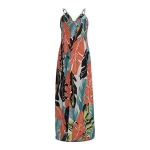 Macro view of tropical leaf print on women's cotton cami maxi dress.