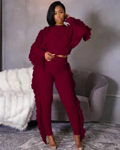 Elegant burgundy two-piece knitted set with fringe detailing and cable knit texture