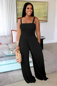 Detailed view of women's solid black smocked wide-leg jumpsuit with straps.