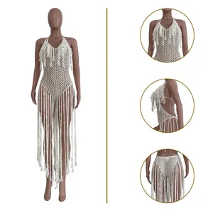 Detailed view of white hollow knit one-piece swimsuit with long tassels and fringe detail