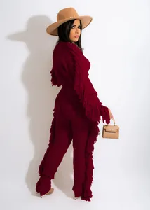 Back view of a wine red knit set featuring long sleeves and decorative side fringe