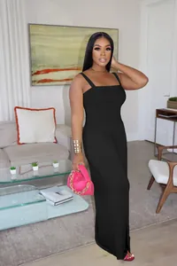 Full view of a black solid color wide leg casual jumpsuit worn by a model in a room.