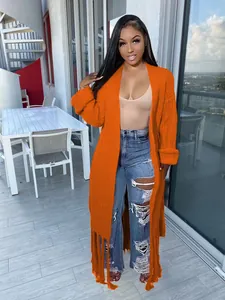 Full-length view of a vibrant orange knitted cardigan with stylish fringe hem details