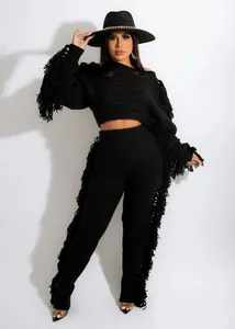Chic black knitted two-piece set featuring long fringe details on sleeves and pants.