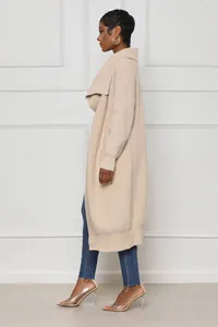 Side profile view of a stylish long beige knit cardigan for women with a ribbed texture