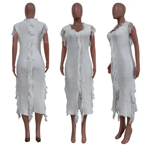 Detailed view of white sleeveless knitted dress featuring central and side fringe trim