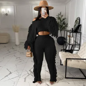 Women's stylish black knitted two-piece set featuring long sleeves with long fringe details
