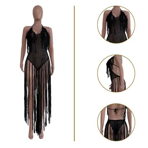 Detail view of black hollow-out knitted bodysuit with long fringes and halter neck.