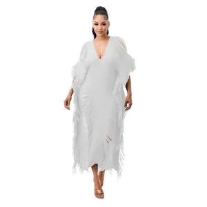 Professional detail view of handmade white knitted maxi dress with fringe and V-neckline.