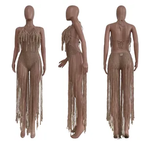 Detail of a beige crochet one-piece swimsuit with long decorative fringe.