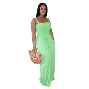 Detailed view of lime green smocked wide-leg jumpsuit with stylish woven handbag