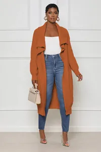Full view of women's long rust-orange knit cardigan showing relaxed fit and texture