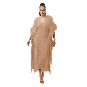 Detailed view of the handmade knit maxi dress featuring elegant fringe and deep V-neckline