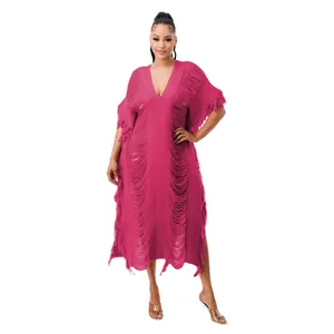 Detail view of a handmade knit fringe maxi dress in vibrant pink with deep V-neckline style