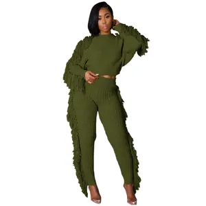Detailed view of the olive green knit two-piece set with side fringe tassel accents