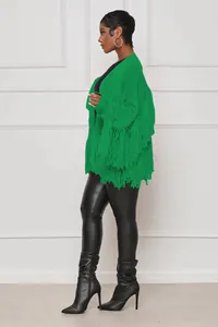Side view of a bright green knit cardigan with tiered fringe details on sleeves