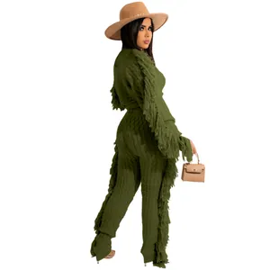Stylish dark green knitted two-piece set featuring trendy fringe details on sleeves and pants