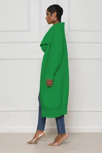 Profile view of a long-line emerald green knit cardigan with textured ribbing