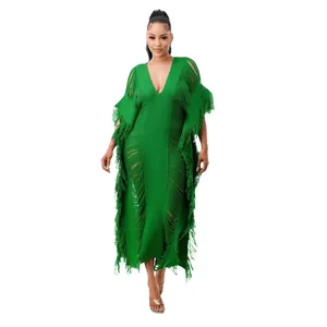 Full-length view of a green hand-knitted see-through dress with elegant long fringes