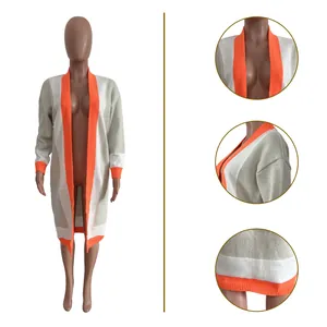 Detail view of long color-block knitted cardigan showing collar, shoulder, and hem