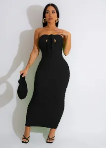 Close-up detail of a sexy black strapless slim-fit maxi dress in textured bubble fabric.