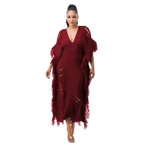 Full-length view of maroon fringed knit maxi dress with deep V-neck and hollow-out design.