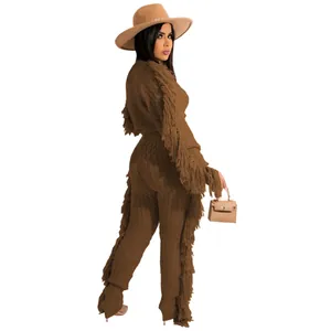 Side view of woman in brown two-piece knit set with long sleeves and fringe tassels