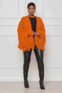 Styling view of a vibrant orange knitted cardigan with long fringe accents and a short cut.