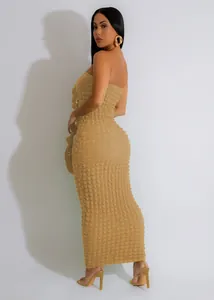 Detail of a sexy slim-fit strapless maxi dress in tan bubble textured fabric.