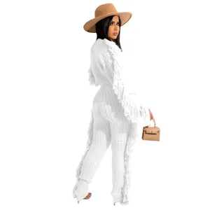 Detailed view of a white knitted two-piece set for women featuring long sleeves and fringe